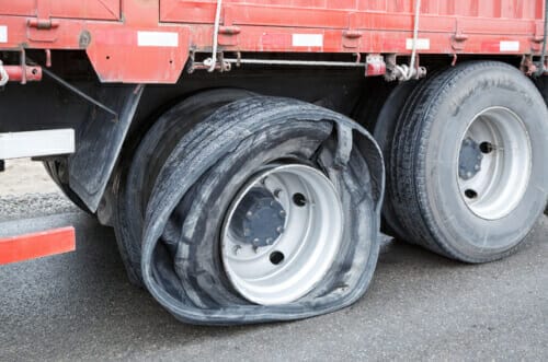 Tractor trailer with a flat tire